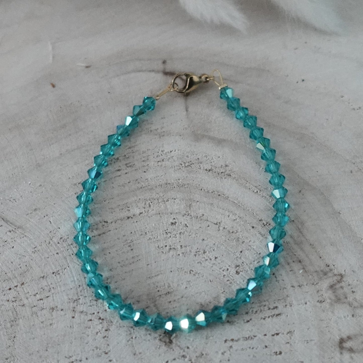 Turquoise beaded bracelet on a textured surface