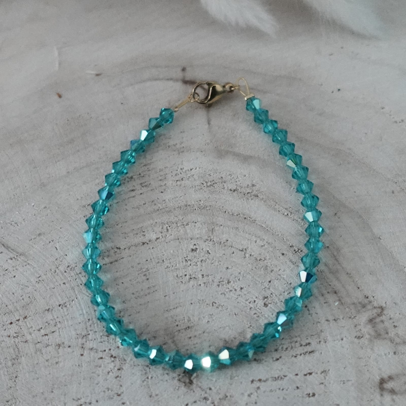 Turquoise beaded bracelet on a textured surface